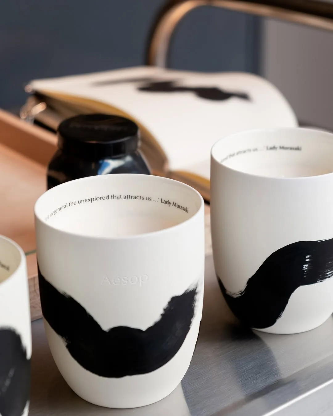 An aromatic, customised keepsake.
Not long ago at Aesop Sendlingerstrasse in Munich, Aromatique Candles were decorated by local artist Ina Streit. With each unique, meandering brushstroke (not dissimilar to ribbons of smoke unfurling after a candle is blown out) the ceramic vessels became one-of-a-kind centrepieces for the home—and perhaps inspiration for any budding painters out there.
Those in the area are welcome to stop by Aesop Sendlingerstrasse on Saturday 7 February from 11am to 5pm, when more candles will be customised by Ina Streit.