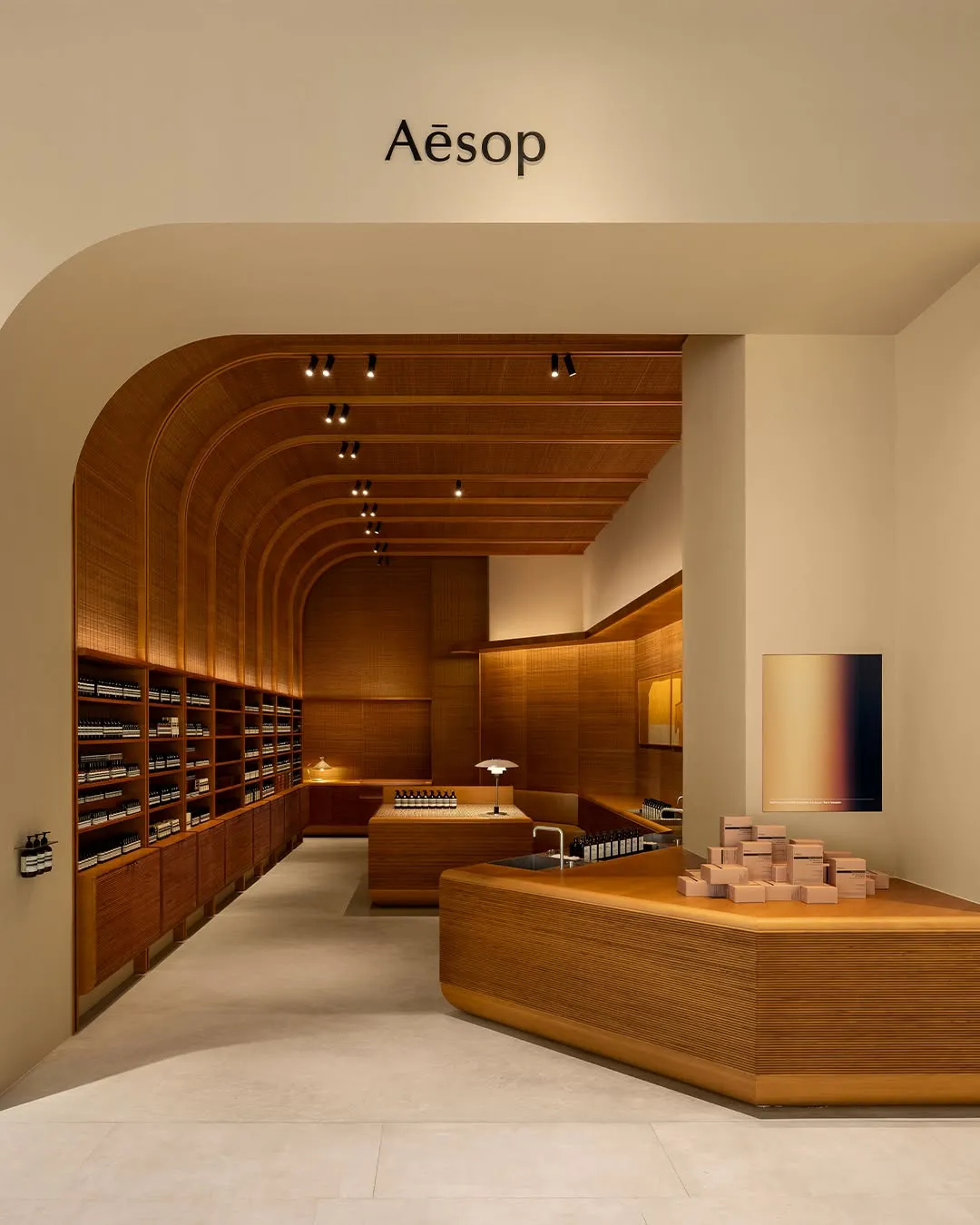Aesop Tainan Nanshan: monumental domesticity.
Recently opened, the store takes cues from the modest grandeur of Tainan’s historic courtyard compounds built by prominent families—later known as Xie houses—with a blend of familial warmth and ceremonial precision. The ceiling and walls echo the cabinetry’s rhythmic repetition of slatted lines, while the trio of basins invites the type of leisurely conversation that might normally take place at home around the kitchen sink.